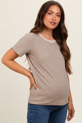 woman wearing a beige and brown striped maternity t-shirt and showing her baby bump