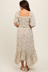 woman wearing a floral maternity dress with a smocked bodice and puff sleeves, showcasing a flowing hemline from the back