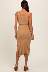 woman wearing a tan ribbed maternity dress with a fitted silhouette and side slit, showing a baby bump from the back