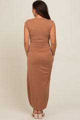 woman wearing a brown cap sleeve maternity maxi dress with back ruching detailing