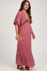 woman wearing a red floral maternity maxi dress with a v-neckline and short sleeves, showcasing her baby bump