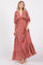 woman wearing a bohemian style maxi dress in vibrant red with patterned detailing and puff sleeves