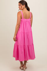 woman wearing a pink tiered maternity dress with adjustable straps and a relaxed fit