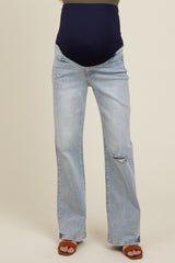 woman wearing light blue maternity jeans with a dark blue belly band and distressed details