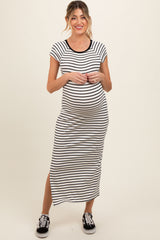 woman wearing a black and white striped maternity maxi dress with short sleeves and a side slit, showing her baby bump