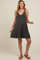 woman wearing a dark gray maternity swing dress with a v-neckline and relaxed fit, showcasing her baby bump