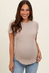 woman wearing a taupe short sleeve maternity top with a curved hem and visible baby bump