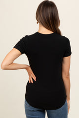 woman wearing a black short sleeve maternity top, seen from the back