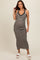 woman wearing a black and white houndstooth maternity dress with a fitted silhouette and lace detailing, showing her baby bump