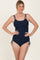 woman wearing a navy ribbed one-piece swimsuit with adjustable ties on the sides and double shoulder straps