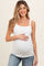 woman wearing a white ribbed maternity tank top and holding her baby bump