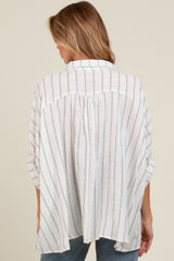 woman wearing a light gray and white striped maternity tunic top, showing the back view and relaxed fit