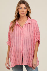 woman wearing a pink striped maternity button-up shirt with a loose fit