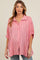 woman wearing a pink striped maternity button-up shirt with a loose fit