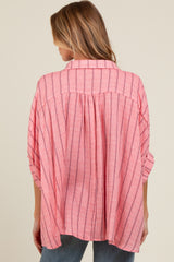 woman wearing a pink striped maternity top with a relaxed fit and back pleating, view from behind