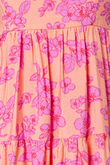 pink floral print sleeveless dress with a tiered skirt and a relaxed fit