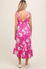 woman wearing a pink floral maternity dress with a smocked back and ruffled straps, no baby bump visible