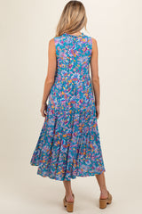 woman wearing a multicolored floral maternity dress with a flowy tiered skirt, viewed from the back