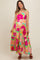 woman wearing a colorful floral print maternity maxi dress with spaghetti straps and a flowy skirt, baby bump visible