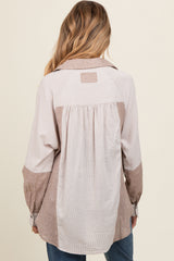 woman wearing a striped long sleeve maternity shirt with a gathered back detail