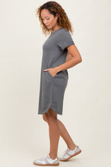 woman wearing a gray short sleeve casual dress with side pockets and a relaxed fit