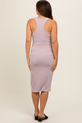 woman wearing a light purple ribbed maternity dress, featuring a racerback design and hugging the baby bump from behind