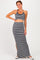 woman wearing a black and white patterned crop top and matching maxi skirt with a side slit