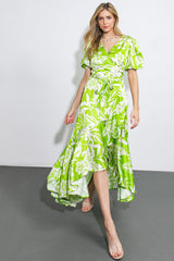 woman wearing a vibrant green floral wrap dress with short puff sleeves and a high-low hemline