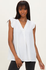 woman wearing a white sleeveless blouse with ruffled sleeves and a v-neckline