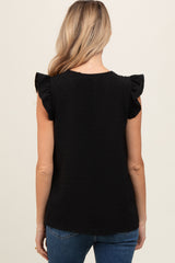 woman wearing a black maternity top with ruffle sleeves, shown from the back
