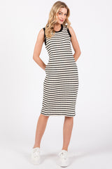 woman wearing a black and white striped sleeveless dress with side pockets and white sneakers