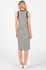woman wearing a black and white striped sleeveless midi dress, view from the back
