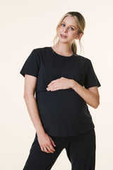 woman wearing a black short sleeve maternity top and holding her baby bump
