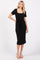 woman wearing a black midi dress with a square neckline and a tie waist detail