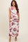 woman wearing a floral maternity maxi dress with a deep v-neck and ruching detail over her baby bump