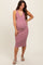 woman wearing a pink ribbed maternity midi dress with a deep V-neck and buttons, showcasing her baby bump