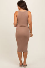 woman wearing a fitted beige ribbed maternity dress with a midi length, shown from the back