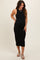 woman wearing a black ribbed maternity midi dress and showcasing her baby bump