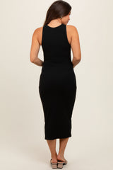 woman wearing a black ribbed maternity midi dress, showing the back view and fitted silhouette