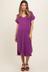 woman wearing a purple maternity dress with a v-neck and short sleeves, showing off her baby bump