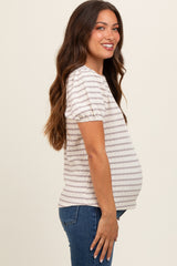 woman wearing a beige and white striped maternity top, showcasing her baby bump from the side
