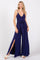 woman wearing a navy blue sleeveless jumpsuit with a tie waist and side slits