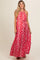 woman wearing a red floral print maternity maxi dress with a halter neckline and a flowing silhouette