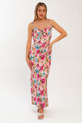 woman wearing a pink floral maxi dress with spaghetti straps and a fitted bodice