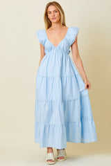 woman wearing a light blue tiered maxi dress with ruffled sleeves and a deep v-neckline