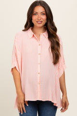 woman wearing a pink and white striped maternity top with short sleeves and button-down front, showing her baby bump