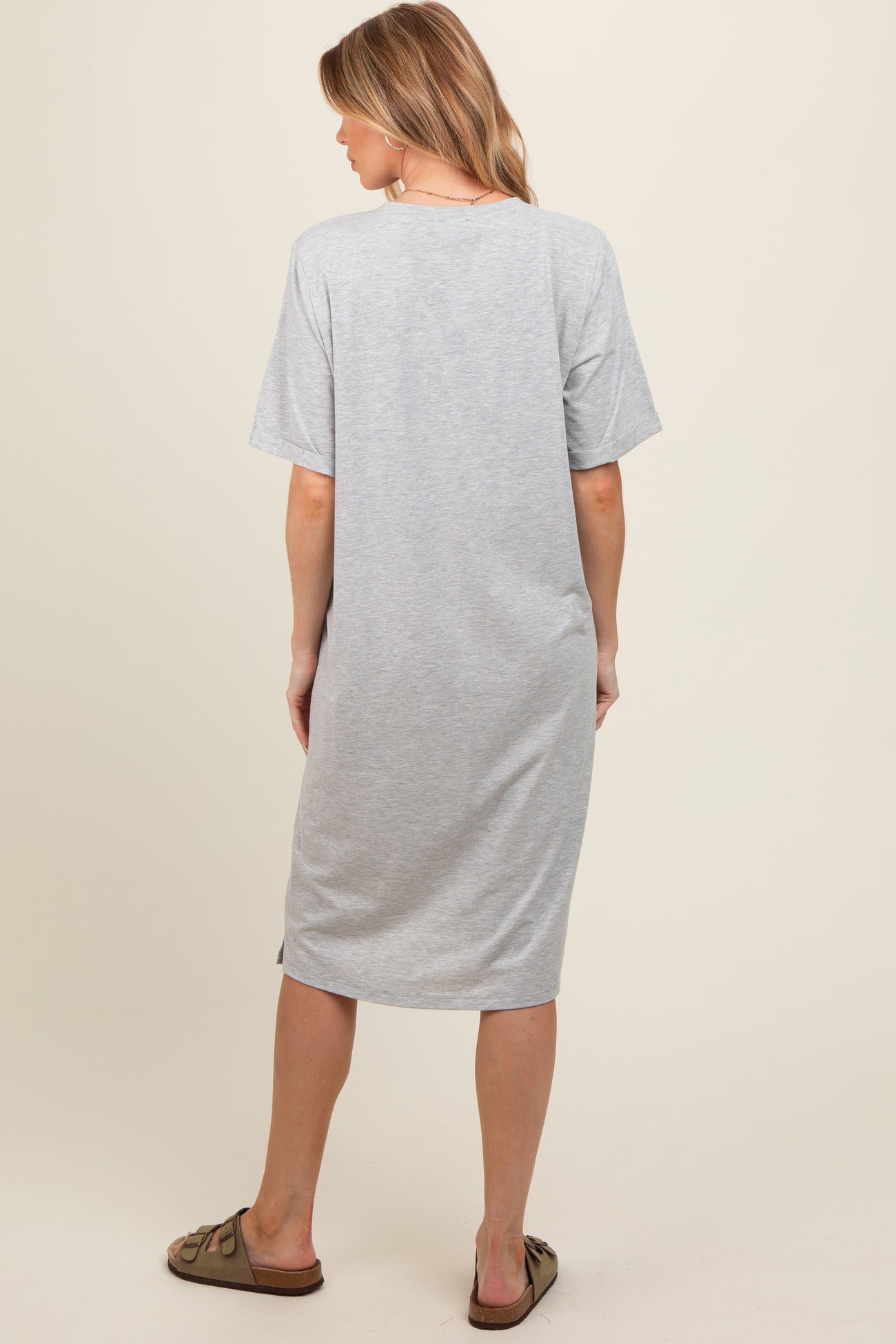 woman wearing a gray maternity dress with short sleeves, viewed from the back, casual style