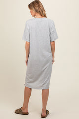 woman wearing a gray maternity dress with short sleeves, viewed from the back, casual style