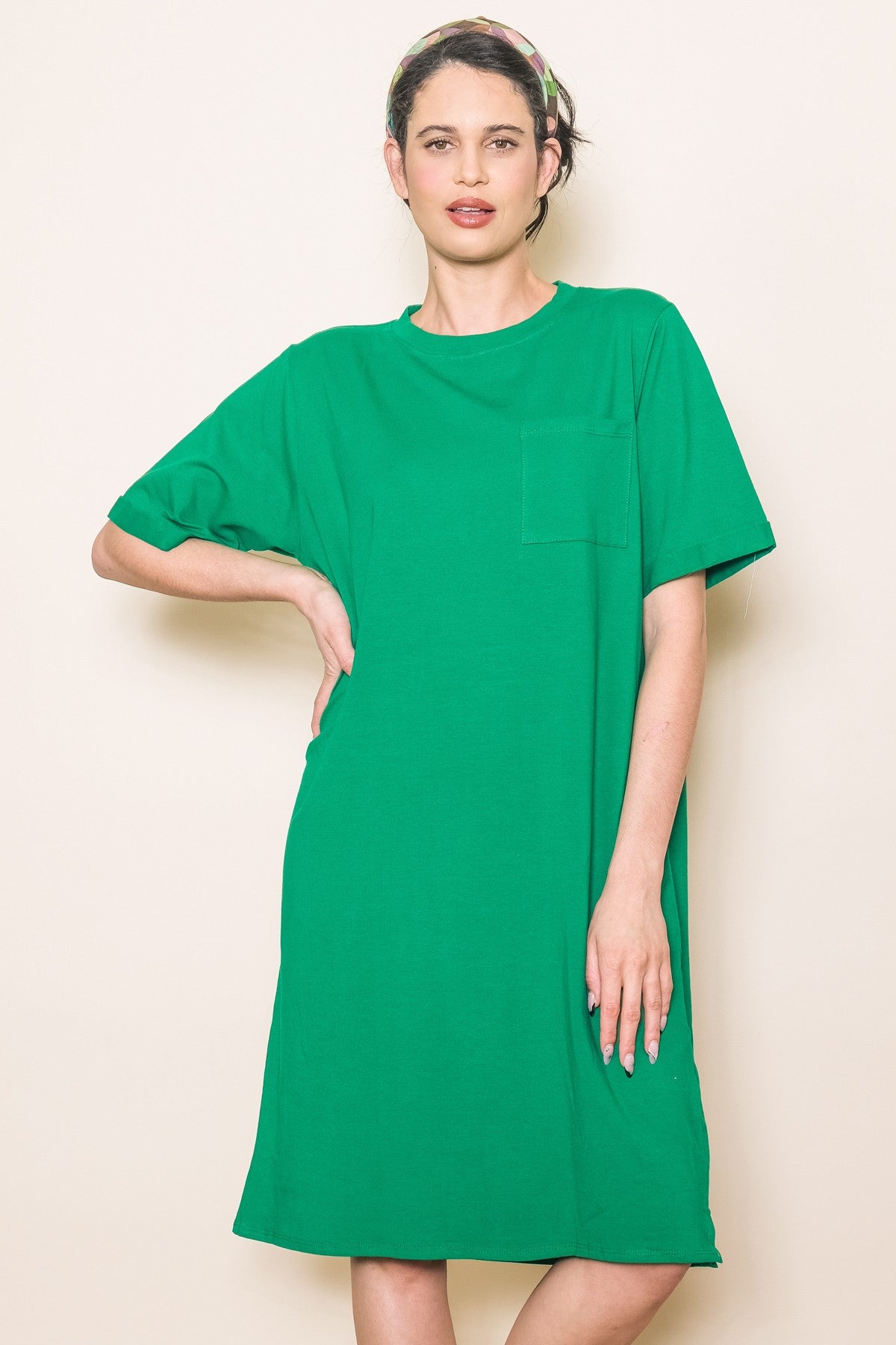 woman wearing a vibrant green short sleeve t-shirt dress with a front pocket