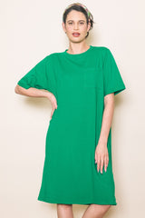 woman wearing a vibrant green short sleeve t-shirt dress with a front pocket